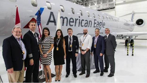 Mesa management and employee representatives at the Bombardier factory delivery ceremony for the first of seven new CRJ900 Next Gen aircraft delivered in 2015.  Photo provided by Mesa.