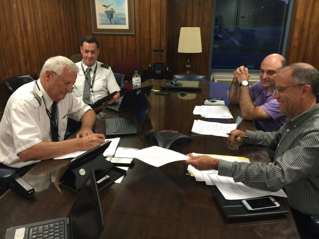 Steve Keefer, VP of Flight Operations (front right) and Scott McGuigan, chief pilot (back right), met with pilots Ron Slater (front left), Jeff Carlino (back left) and Peter Genero (not pictured) to craft an agreement offering Piedmont pilots an industry leading pay package. Image provided by Piedmont Airlines
